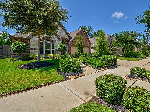 The sidewalk in front of the home ties the neighborhood together and makes for walks with dog or riding bikes with the family even safer. The landscaping flows from the yard over the sidewalk to the curb, what a nice added touch!