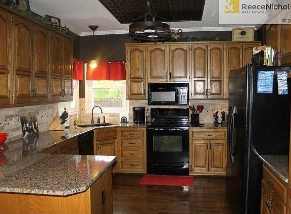 Updated faux cabinets, granite countertops, custom backsplash