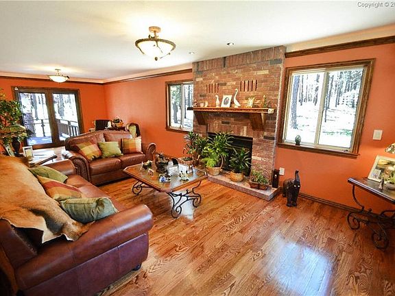 Wood burning fireplace and hardwood floors in the elegant living room.