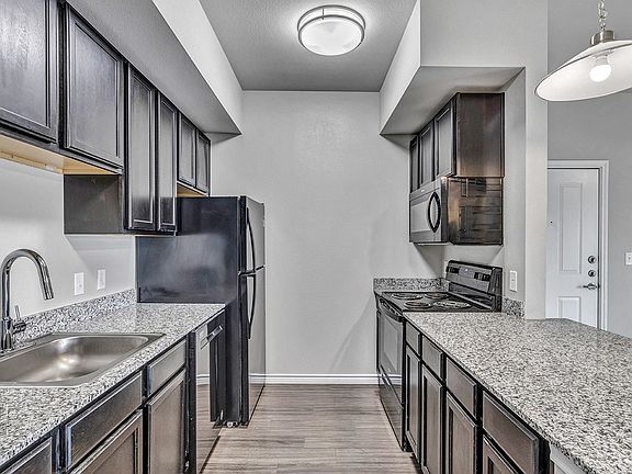 Enjoy granite countertops, stainless steel farm sinks, and black appliances