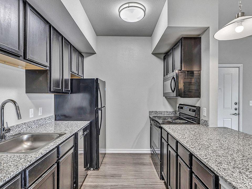 Enjoy granite countertops, stainless steel farm sinks, and black appliances