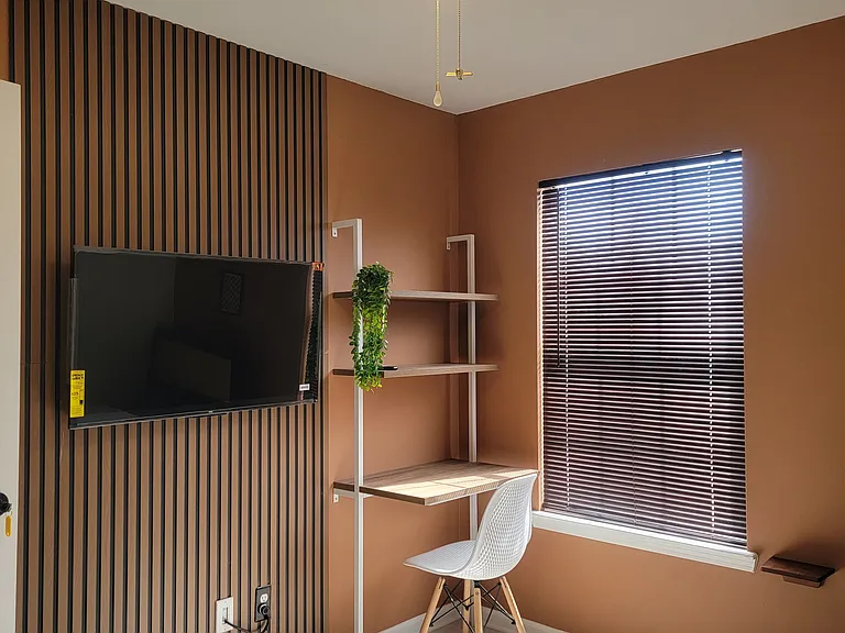 Every bedroom comes with a TV, an accent wall, and a workspace.