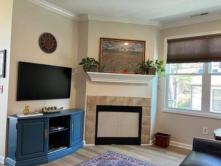 High Definition Smart TV, games, leather reclining couch with chargers and game table.