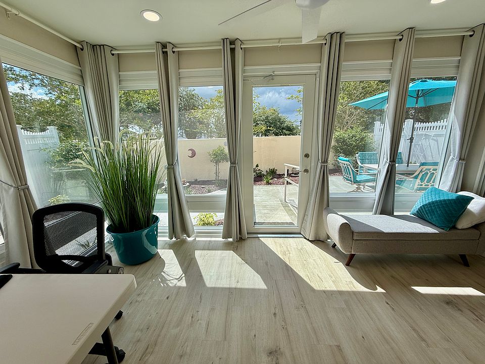 The Florida Room/Den lets in natural daylight while providing a spectacular view of the courtyard patio. The room is equipped with a portable desk, computer, printer, an office chair, a window bench, and portable tables.