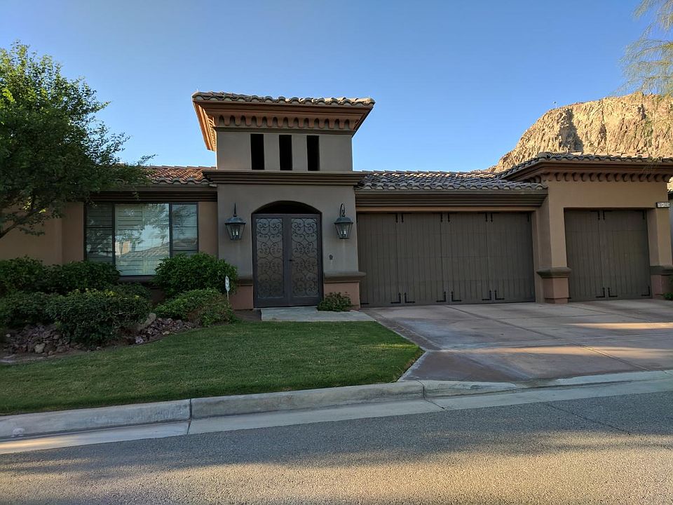Front of home: 3 car garage with storage, security gates
