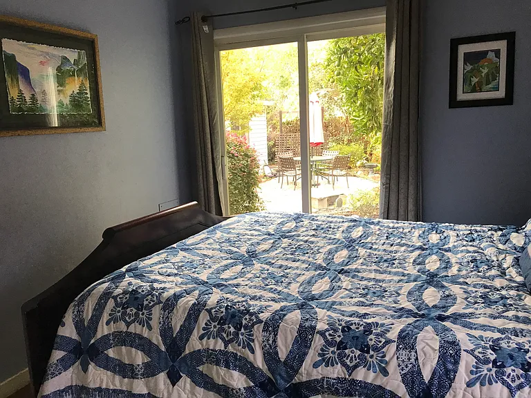 Both bedrooms have views and access to the garden and waterfall.