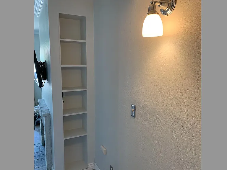 Hallway with built in book shelf