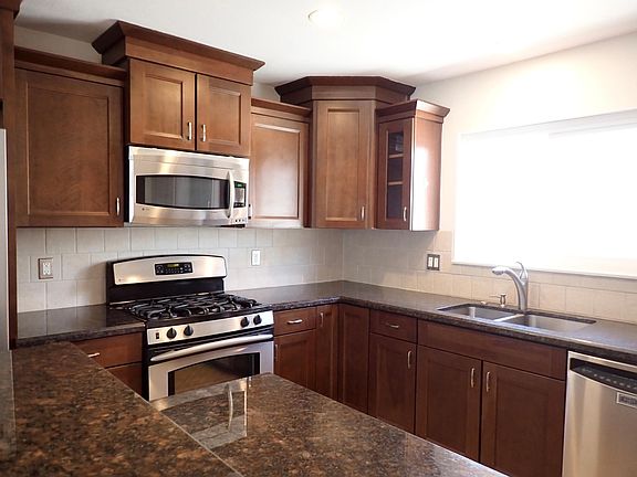 Spacious kitchen with granite counter tops, stainless appliances