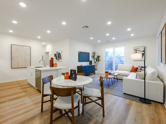 Plan 1A model home spacious great room connecting kitchen, dining, and living area