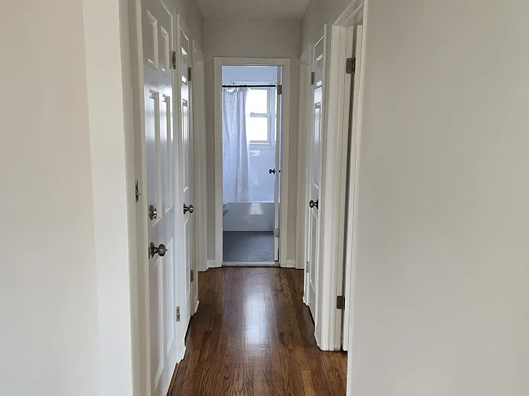 Hall with freshly finished hardwood floors.