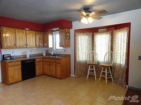 Lots of kitchen cabinets and tile flooring.