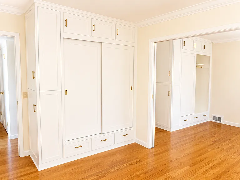 Twin bedrooms with closets, divided by sliding door.