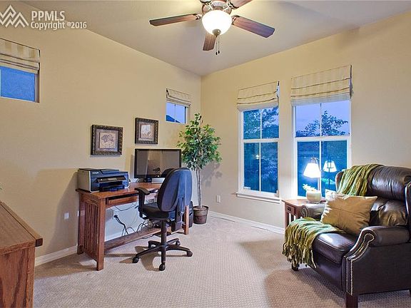 The front Bedroom (currently used as an office) features a lighted ceiling fan &