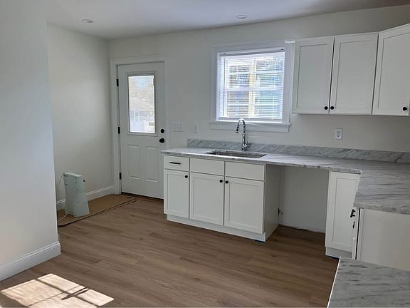 Kitchen w/granite countertops. Rear entry w/access to covered rear deck.