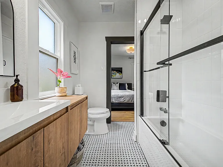 View looking from secondary bedroom into the jack/jill updated bathroom