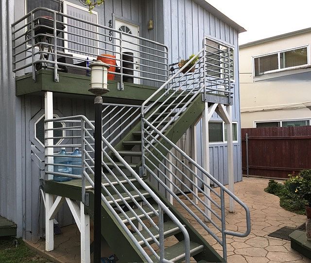 Stairs leading to front deck and door.