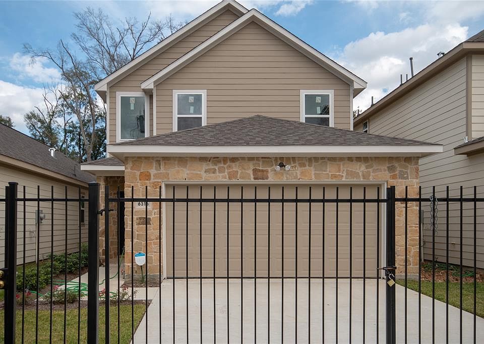 2 story stone elevation in Cebra Manor in Acres Home that is gated. living in country easy access to downtown or galleria