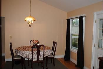 Eating area with view of the spacious backyard and large deck.