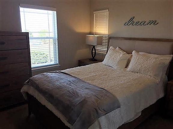 Middle bedroom with queen bed and mountain views