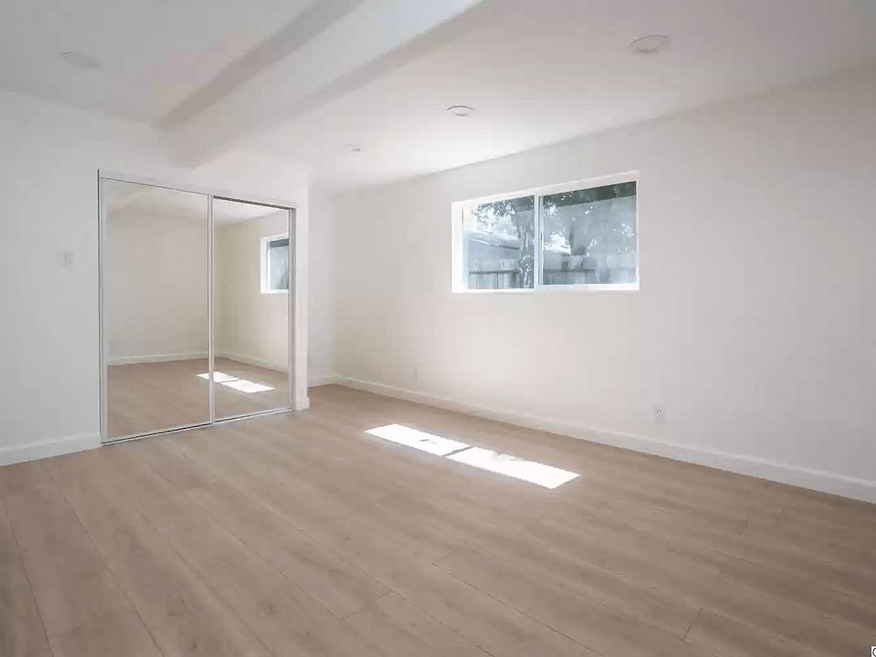 Empty view of primary bedroom and closet. Can also be used as a living room.