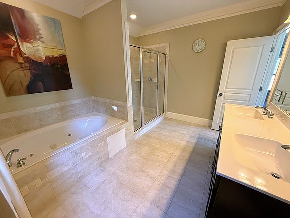 The entire top floor is the Primary Suite with King Bed, TV, sitting area (multi-purpose), large walk-in closet, and enormous en suite bathroom with double vanities, Whirlpool Tub & separate dual head shower for 2!