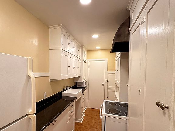 Retro Galley Kitchen with Granite Counters; Glass Top Range