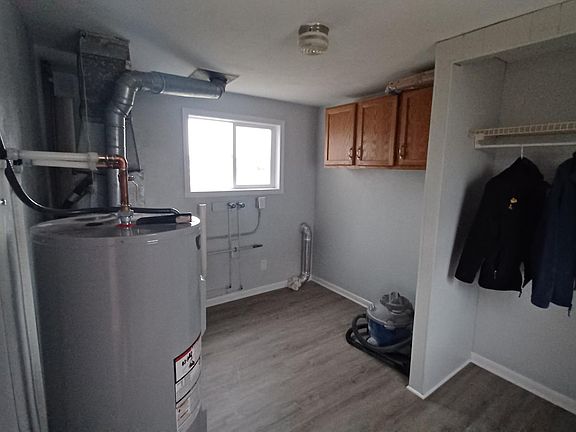 Entry into utility room with washer and gas dryer hook up. Closet and cabinet space.