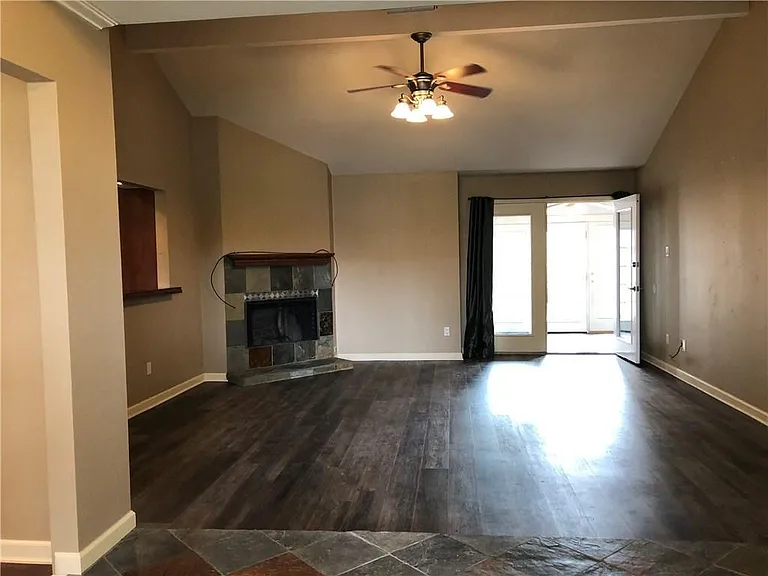 Spacious living room with sunroom for additional living area.