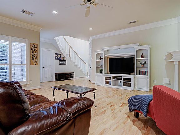 The natural flow of the home draws you into the living area that has plantation shutter covered windows.