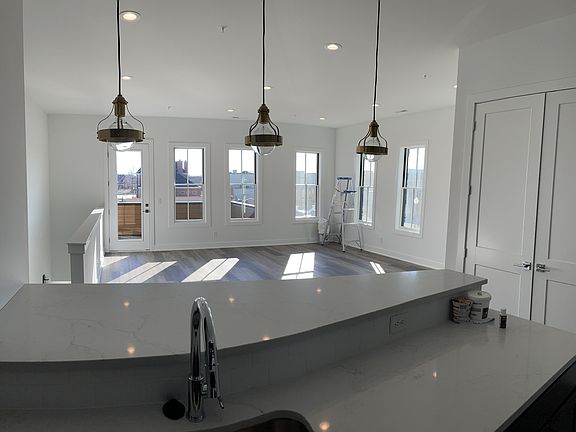 Kitchen looks directly into the living room and exterior 2nd level balcony.
