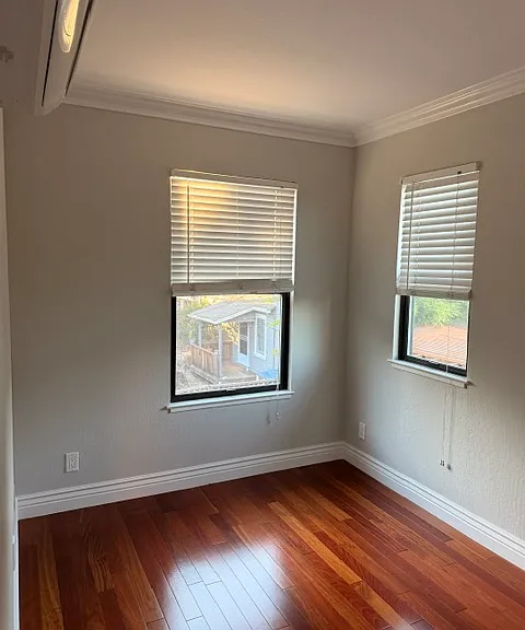 Bedroom with new windows. Blinds are existing. See Panasonic mini-split unit to the upper left.