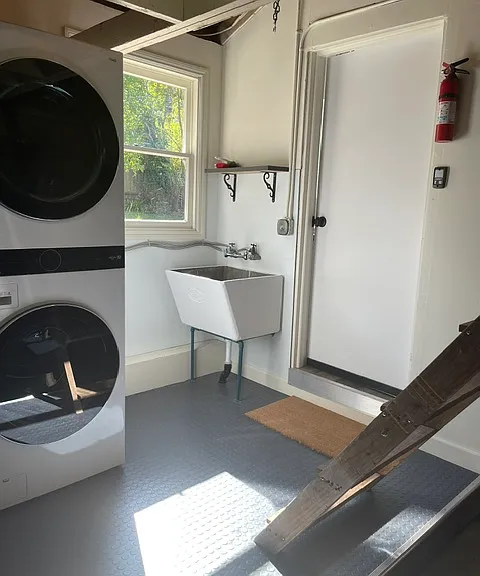 Door to kitchen from laundry / garage. steps on the right go up to storage loft, steps latch into ceiling when not in use