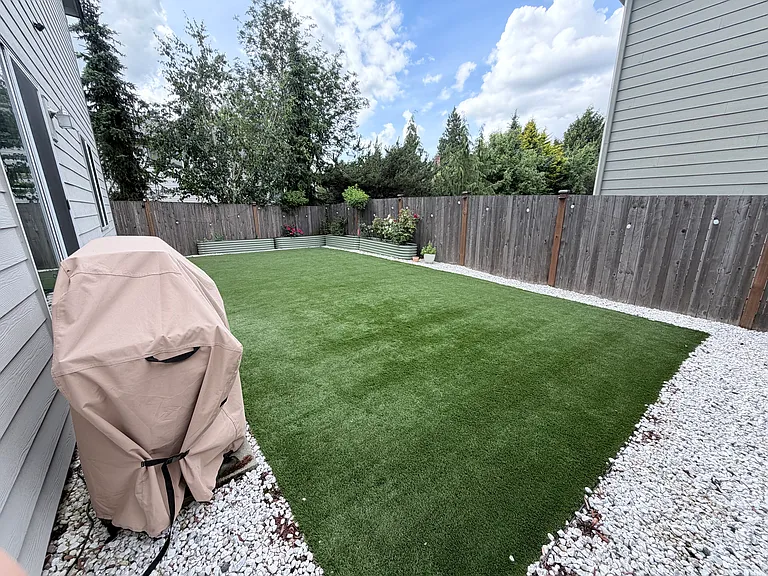 Back yard - Turf with raised garden. 6 Burner Stainless Steel Propane Gas Grill