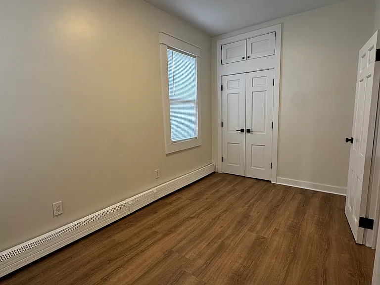 Bedroom 2 (Actual Room): Bright and inviting bedroom with generous natural light, a spacious closet, and overhead storage for added organization. Perfect for a comfortable bedroom or guest room