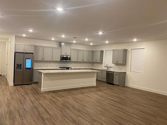 The spacious kitchen, featuring a Smart Fridge and a generous pantry, combines modern technology with ample storage. It's the perfect space for cooking, organizing, and enjoying seamless convenience.