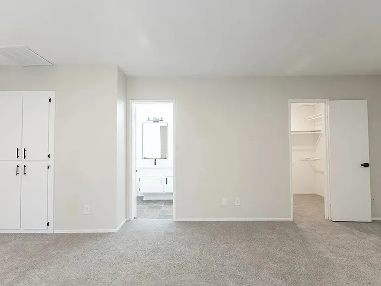 another view of upstairs bedroom with view of linen closet, bathroom and closet. units vary