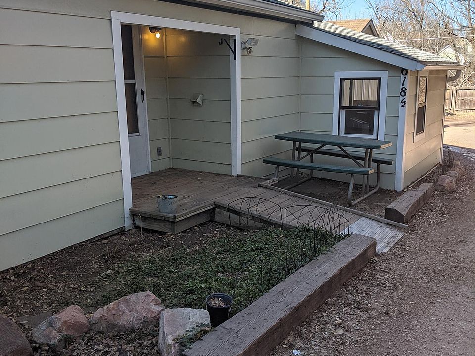 The cottage behind the house. An adorable small front yard.