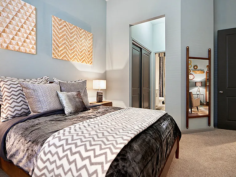 Plush carpeting and ceiling fans in bedroom
