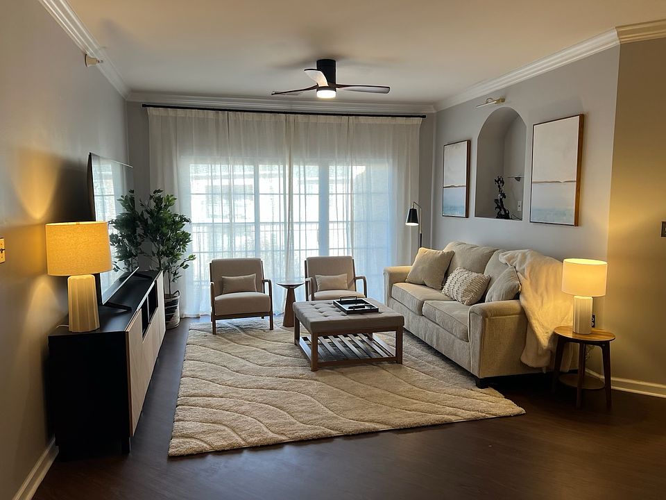 The living room space showed furnished as reference