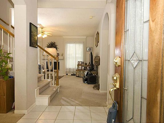 THE GLASS DOOR OPENS TO A WARM AND WELCOMING HOME. TILE FLOORING LEADS TO THE DINING ROOM AND THE FAMILY ROOM.
