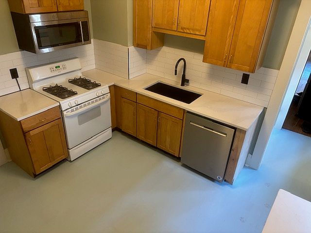Updated Kitchen with Quartz countertop, dishwasher, microwave, and new composite sink.