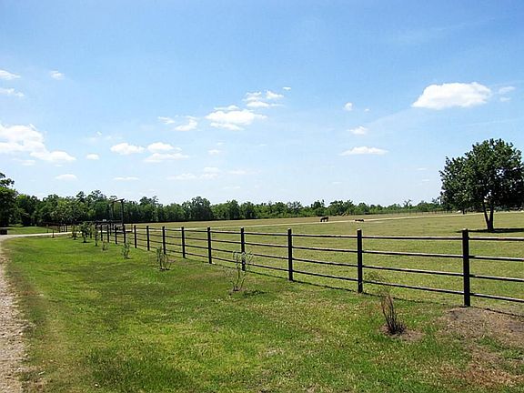 VIEW OF FRONT OF PROPERTY AS YOU APPROACH ENTRANCE GATE