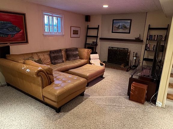 Family room/entertainment room with a rare and cozy second wood burning fireplace.