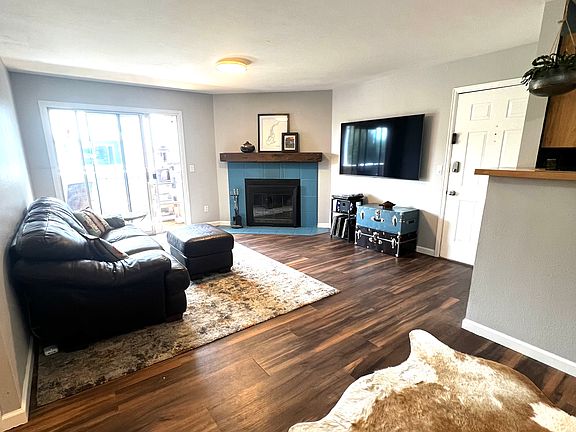 Large sunny living room opens to dining room and kitchen