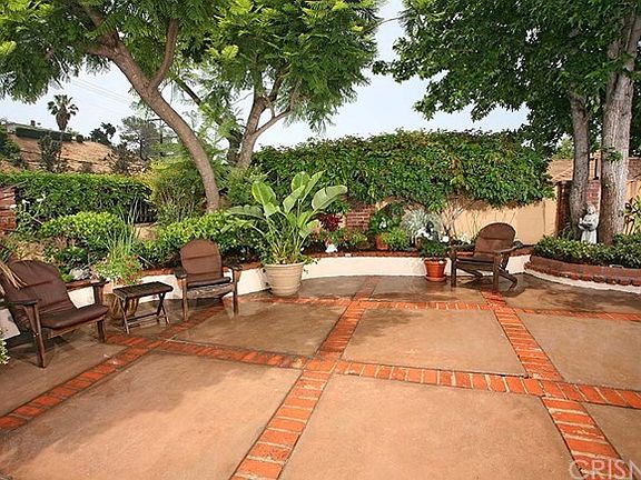 Courtyard surrounded by gardens of flowers and plants