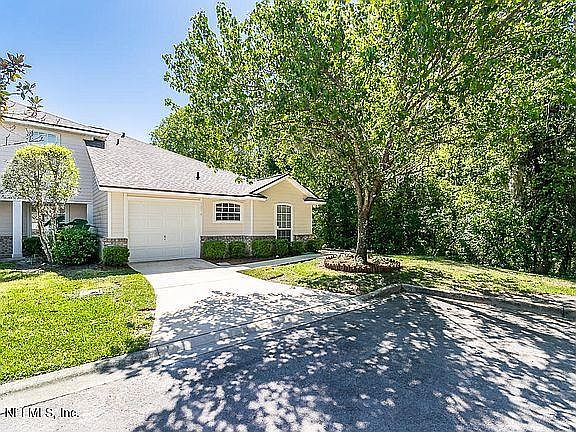 End unit single story townhome on a quiet cul-de-sac beside a natural preserve area