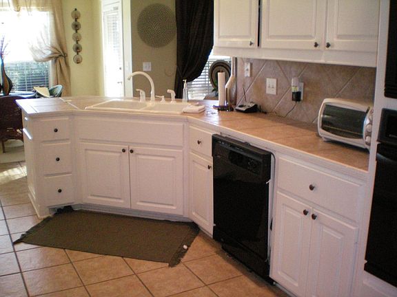 Kitchen with ceramic tile counters and floors and eat in area