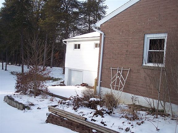 148 S. Sutton Rd Side with Overhead Door to Basement Storage