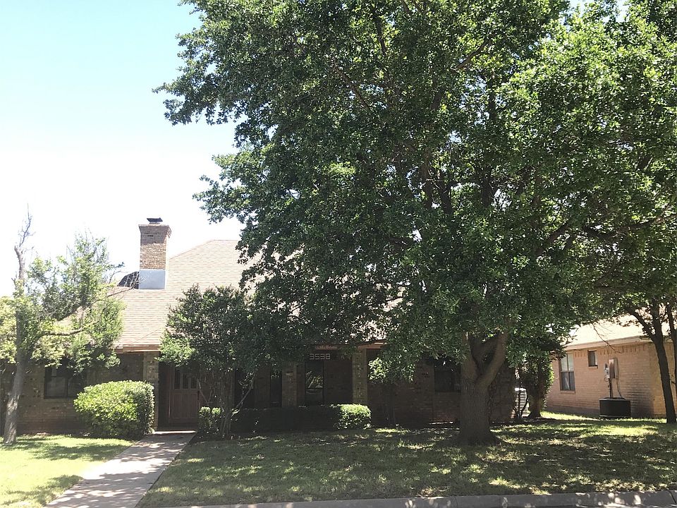 Front of house has a nice shaded yard and a covered porch.