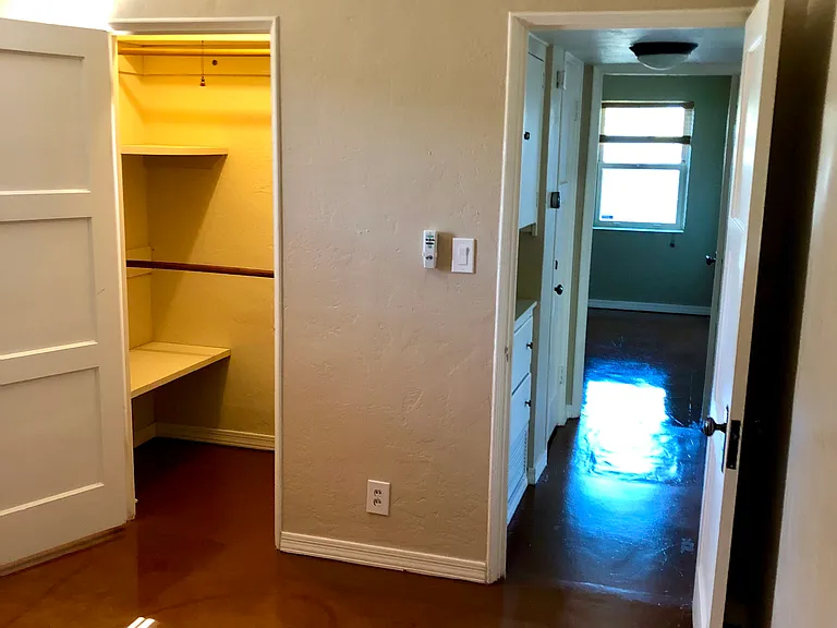 2nd bedroom that had blue queen size bed. Closet with Double rod hanging closet with shelves. Closet is larger than what it appears.